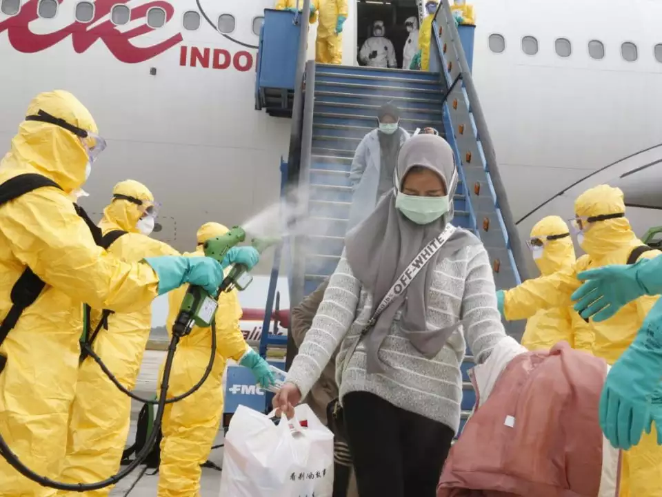 photos-and-videos-show-officials-in-hazmat-suits-spraying-passengers-with-mist-as-they-arrive-in-indonesia-amid-coronavirus-scare photos-and-videos-show-officials-in-hazmat-suits-spraying-passengers-with-mist-as-they-arrive-in-indonesia-amid-coronavirus-scare